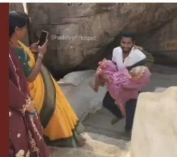 Man carries his grandmother, 90, atop Anjanadri Hill