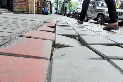New footpath is broken, but BBMP has installed decorative lights, marble benches
