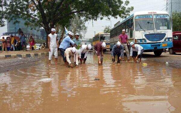 AAP, NGO plant paddy on waterlogged streets in protest