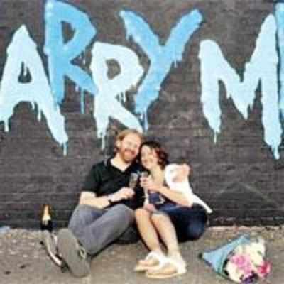 Graffiti artist sprays proposal on wall