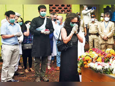 The final goodbye: Deepak Sathe’s wife and sons pay their last respects before his cremation