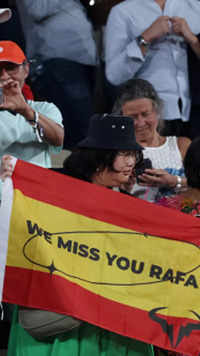 ​Fans holding a flag with reads “We miss you Rafa”