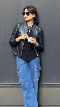Stylish in simple bell-bottomed jeans and black jacket