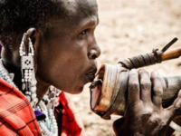 Maasai <i class="tbold">spitting</i>
