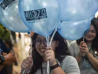 ​People hold balloons to mark 10 years of <i class="tbold">plane</i> disappearance