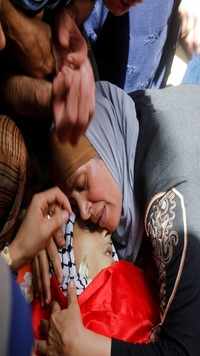 The mother mourns over her son's body, who was killed during clashes with Israeli forces.