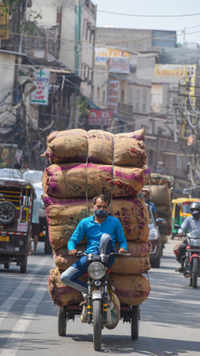 Man carries load on an e-rickshaw at Chandni Chowk in Old Delhi.