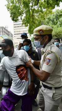 Police personnel attempts to detain an IYC activist.