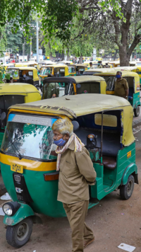 <i class="tbold">auto driver</i>s wait in front of a prepaid auto counter for their turn.