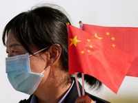 Woman holds Chinese flag during the lift off