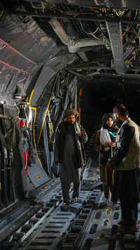 Taliban fighters inside an Afghan air force aircraft at the airport in Kabul.