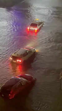 Vehicles are stranded on a flooded road in Yonkers.