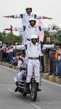 Members of BSF Gujarat Frontier daredevil team perform with <i class="tbold">motorbike</i>s.