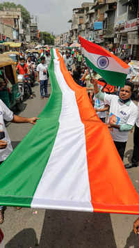 People carry a 75ft long <i class="tbold">indian national flag</i> during a rally in Ahmedabad.