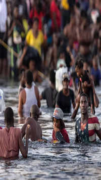 Immigrants, mostly from Haiti gather on the bank of the <i class="tbold">rio grande</i> in Ciudad Acuna, Mexico.