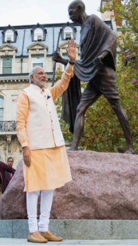 Modi waves to supporters after paying homage at Mahatma Gandhi Statue in front of Indian Embassy in US.
