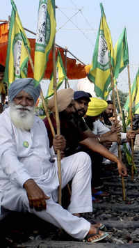 Members of Bhartya Kisan Union Ugrahan block the railway tracks during farmers' Bharat Bandh strike.