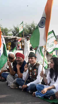 Farmers with supporters block a road during their <i class="tbold">bharat bandh</i> strike.