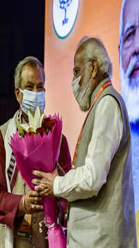 Prime Minister Narendra Modi recieves a bouquet from Bharatiya <i class="tbold">janata party</i> (BJP) Delhi president Adesh Gupta.