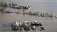 ​A farm surrounded by floodwaters in Abbotsford, <i class="tbold">british columbia</i>, Tuesday.
