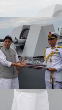 Rajnath Singh receives a memento from Indian Chief of Naval Staff Admiral Karambir Singh.