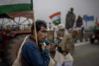 ​A farmer smokes a bidi during a tractor rally to protest new farm laws in Ghaziabad, on the outskirts of New Delhi.