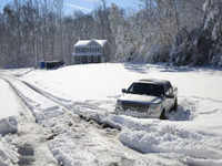 A pickup <i class="tbold">truck</i> sits abandoned after sliding off the road in icy conditions January 04
