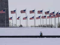 P​eople jog around the National Mall after a snowfall in the Washington, DC, region, on January 7.