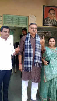 Gujarat BJP general secretary Rajni Patel & his family members show their ink-marked fingers