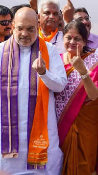 Union home minister Amit Shah & his wife Sonal show their ink-marked fingers in Ahmedabad
