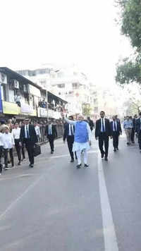 PM Modi walks towards his polling booth to cast his vote in Ahmedabad