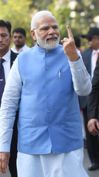 PM Modi showing inked finger after voting