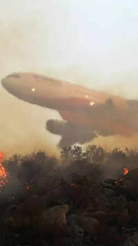 An aircraft drops retardant on Fairview Fire burning near Hemet at California in US on September 6