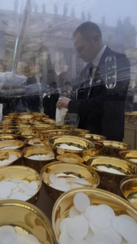 Holy communion vessels are filled ahead of the funeral mass