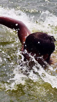 A boy swims in <i class="tbold">ambazari</i> Lake to beat the scorching heat in Nagpur.