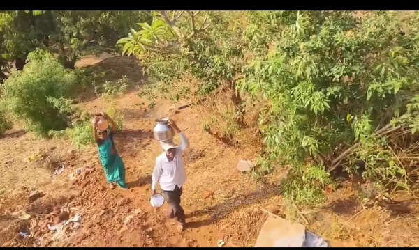Tribal women brave fall risk in water walk on steep hillsides
