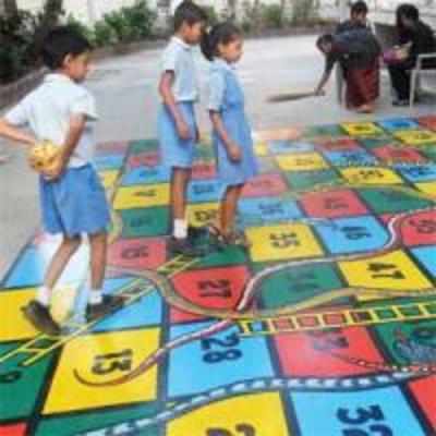Students play Snakes and Ladders to learn Math