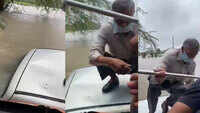 On cam: Retired cop rescued after his car gets stranded in flooded river 