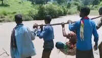 Kin carry pregnant woman on makeshift basket to reach ambulance 