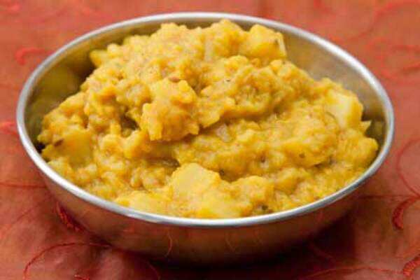 Cooking moong dal with raw banana