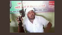 Independent candidate Ram Chandra Yadav brandishes gun at a press conference 