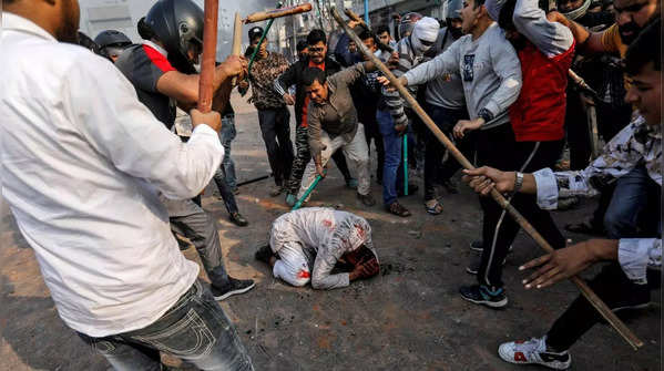 A group of men chanting pro-Hindu slogans, beat Mohammad Zubair, 37, during CAA protests in Delhi (Photo: Reuters)