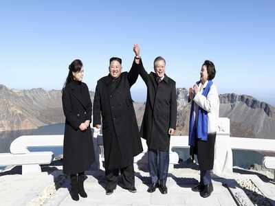 Kim Jong Un, Moon Jae-in join hands on peak of sacred North Korean volcano