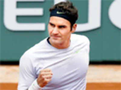 Federer dances into fourth round