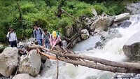 People using makeshift wooden bridge to cross river stream in Uttarkashi 