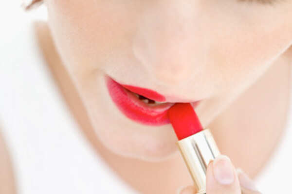 Applying dark lipstick