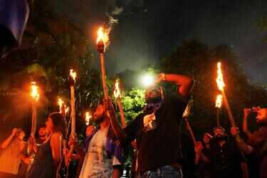 Cops enter SRFTI campus at night after torchlight march