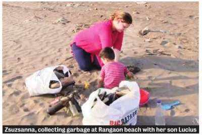 Hungarian woman, her husband and children clean Vasai beach