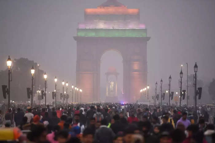 Individuals taking pleasure in the New Year night at Kartavya course in New Delhi