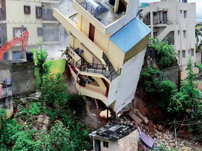 Two more buildings tilt, third collapses
